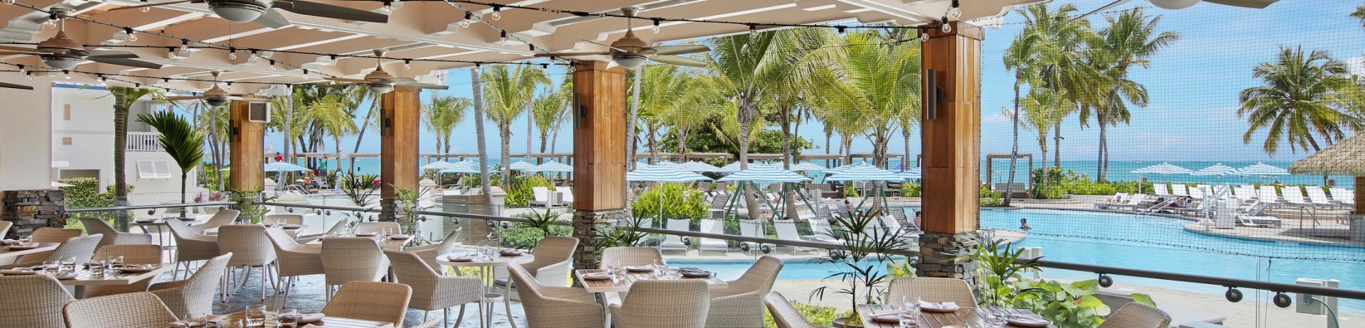 outdoor dining area with white chairs next to the pool