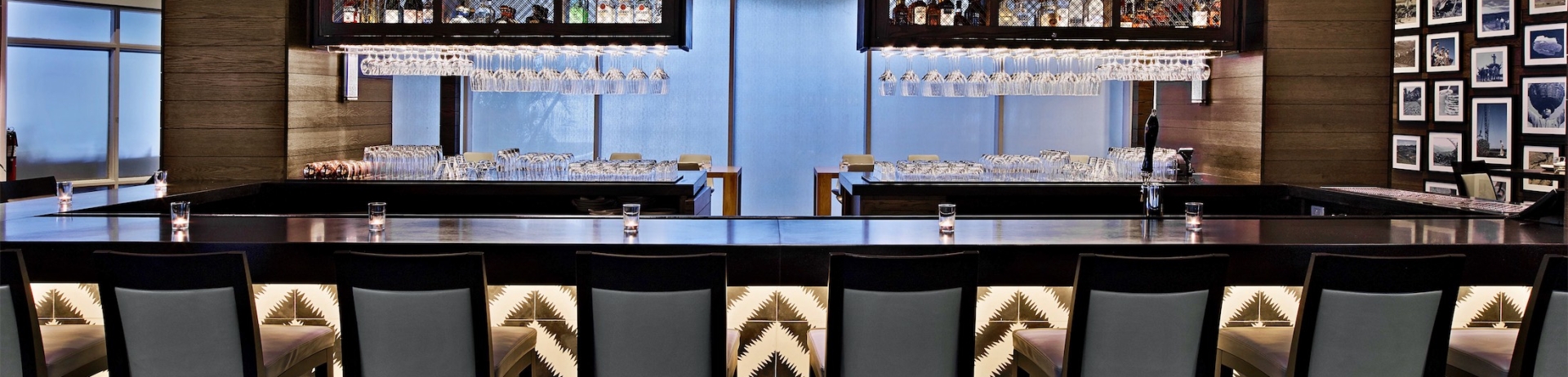 bar area with hanging wine glasses