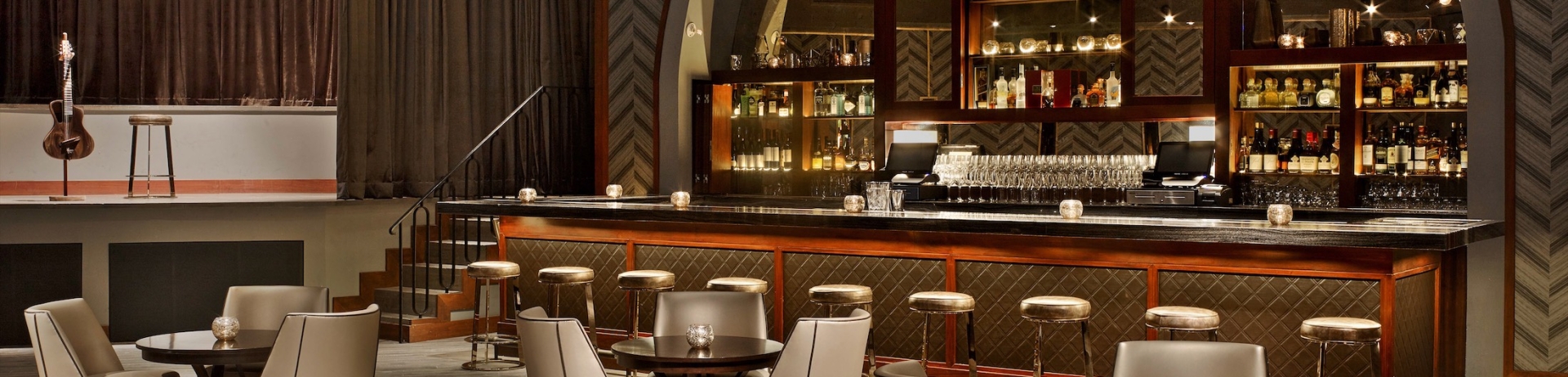 bar with seating and a stage for live entertainment