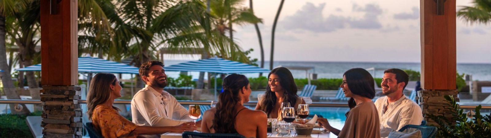 A group of friends dining outdoors at sunset