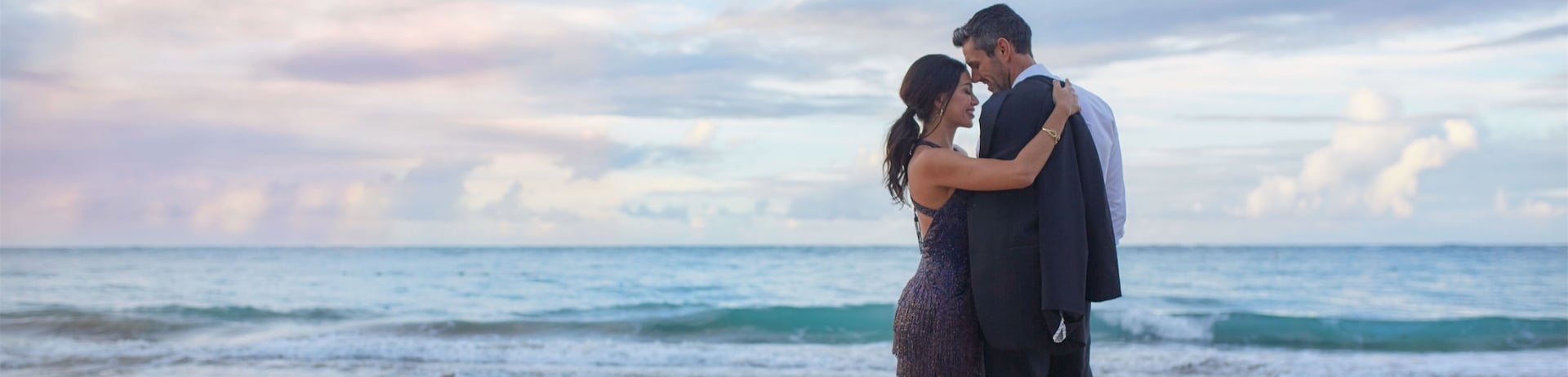 man and woman hugging on the beach