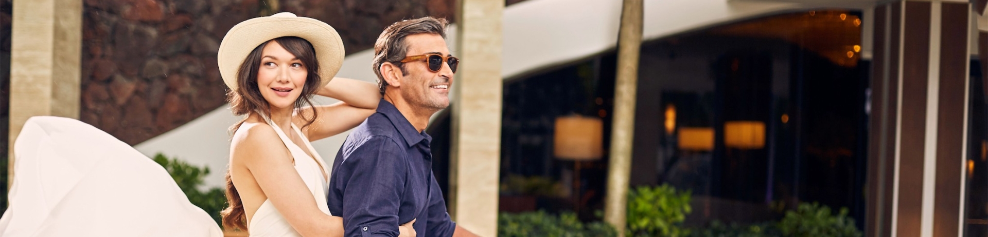 side view of a couple riding a vespa