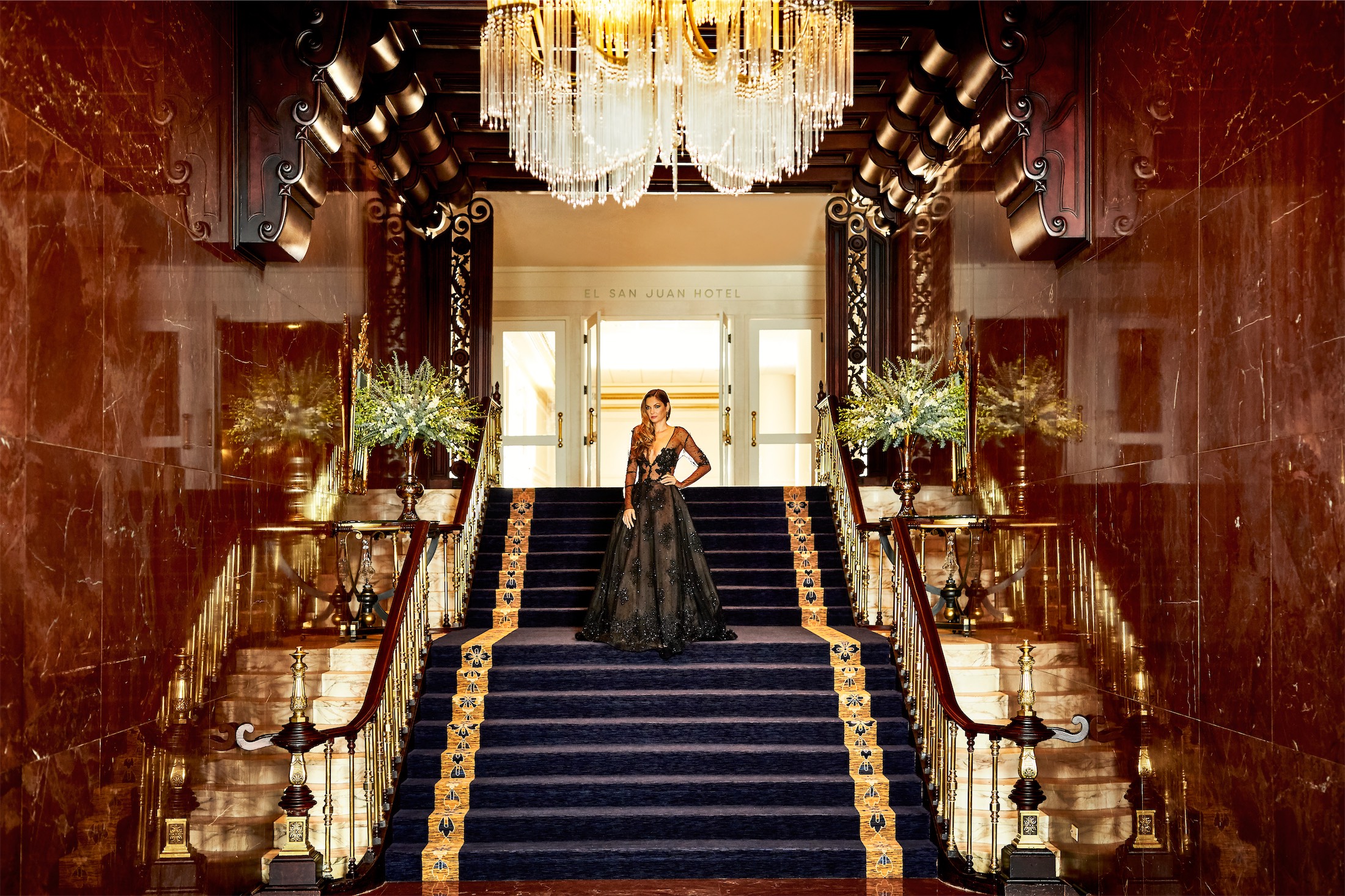 woman in a dress standing on stairs