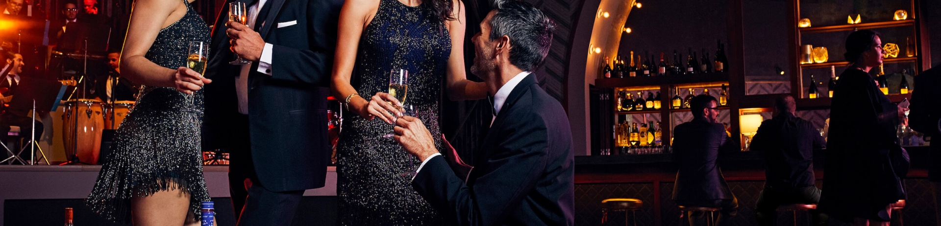 two couples dancing at a bar