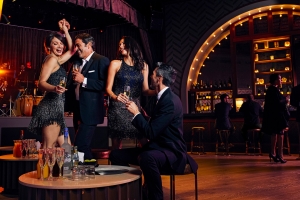 two couples dancing at a bar