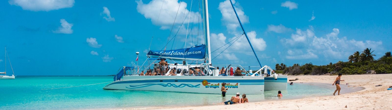 people on a boat next to the beach