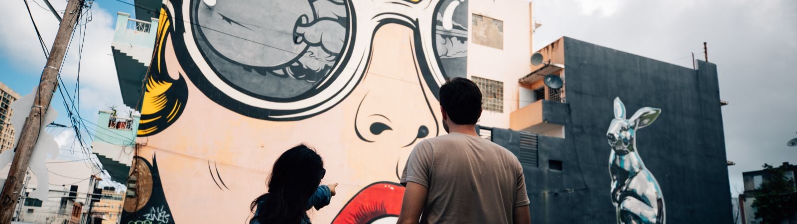 two people looking at an art mural