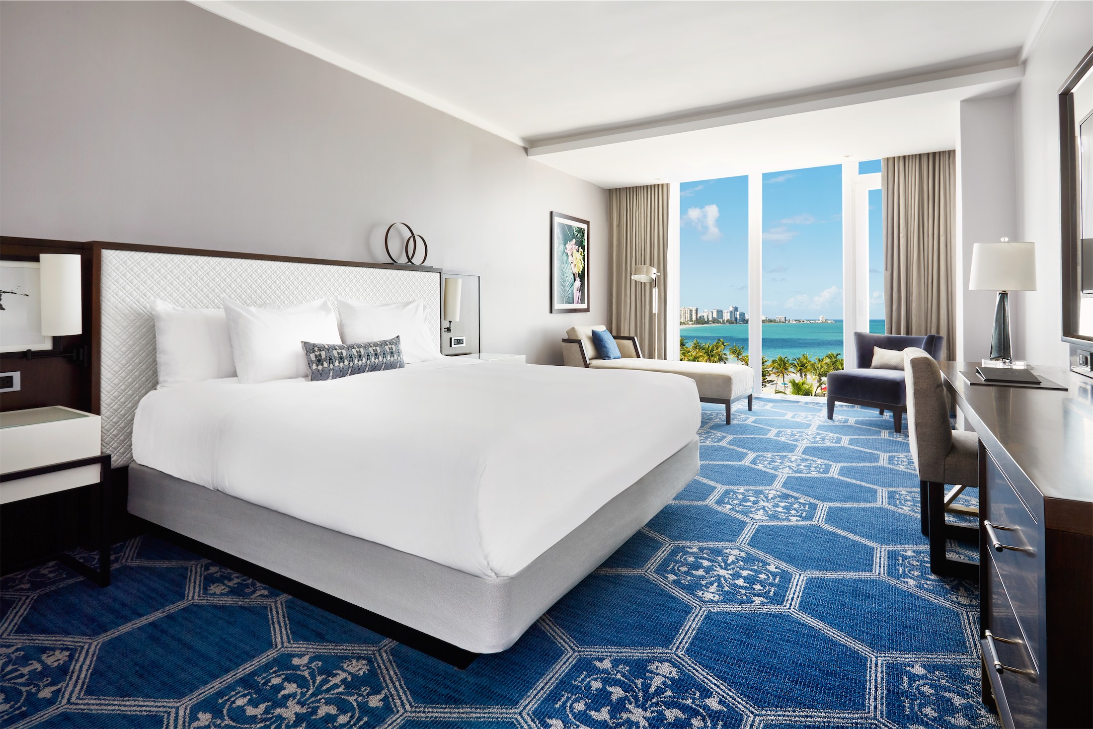 bedroom with blue carpet and great view of the ocean