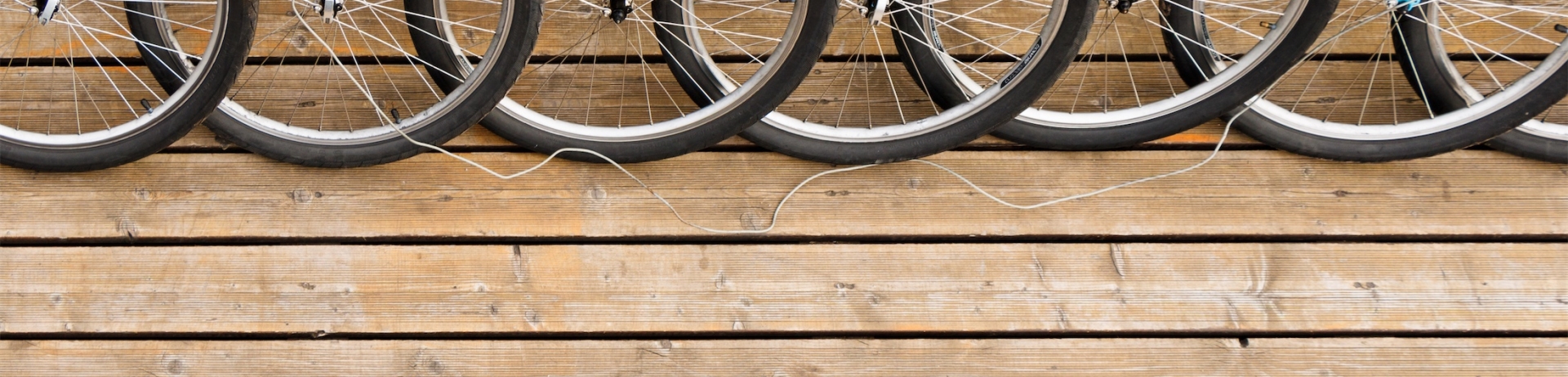 close up of front bike tires on a wood floor