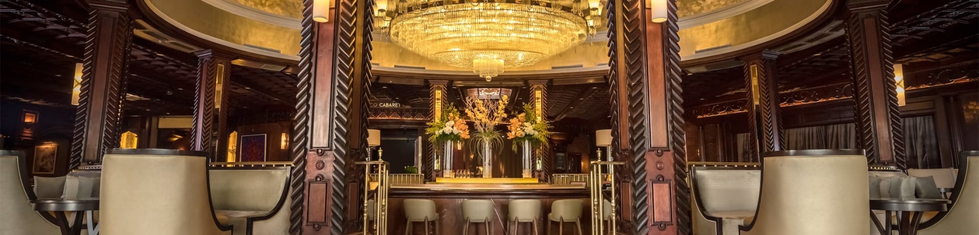 large, open bar space with a large chandelier overhead