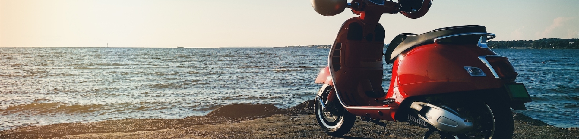 electric scooter parked next to a beach