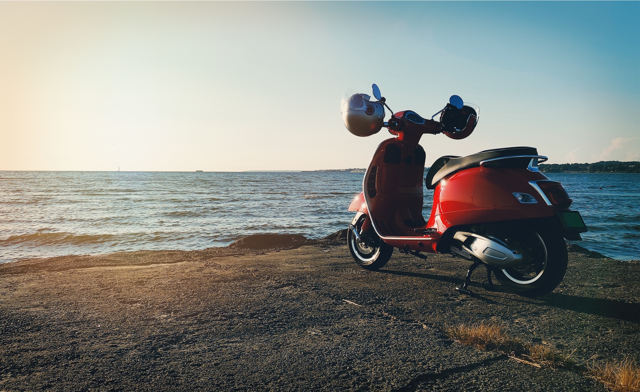 electric scooter parked next to a beach