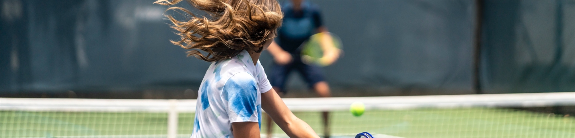 two people playing tennis on a court