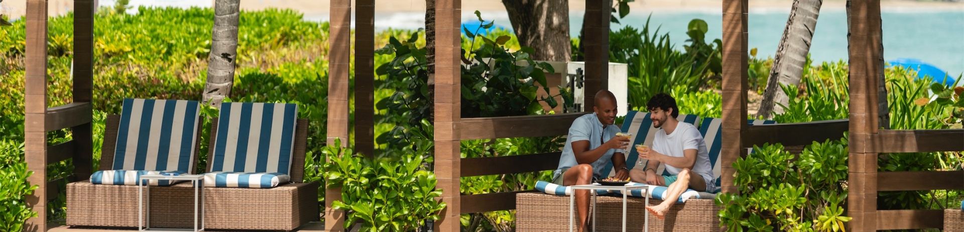 a couple sitting in a cabana