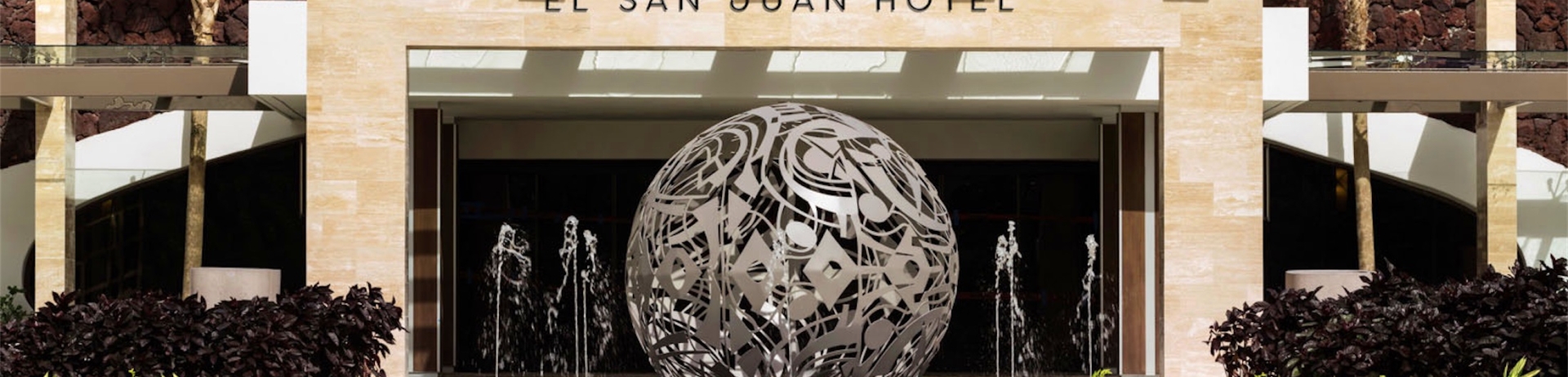 entrance of the property with a circle pattern in the driveway