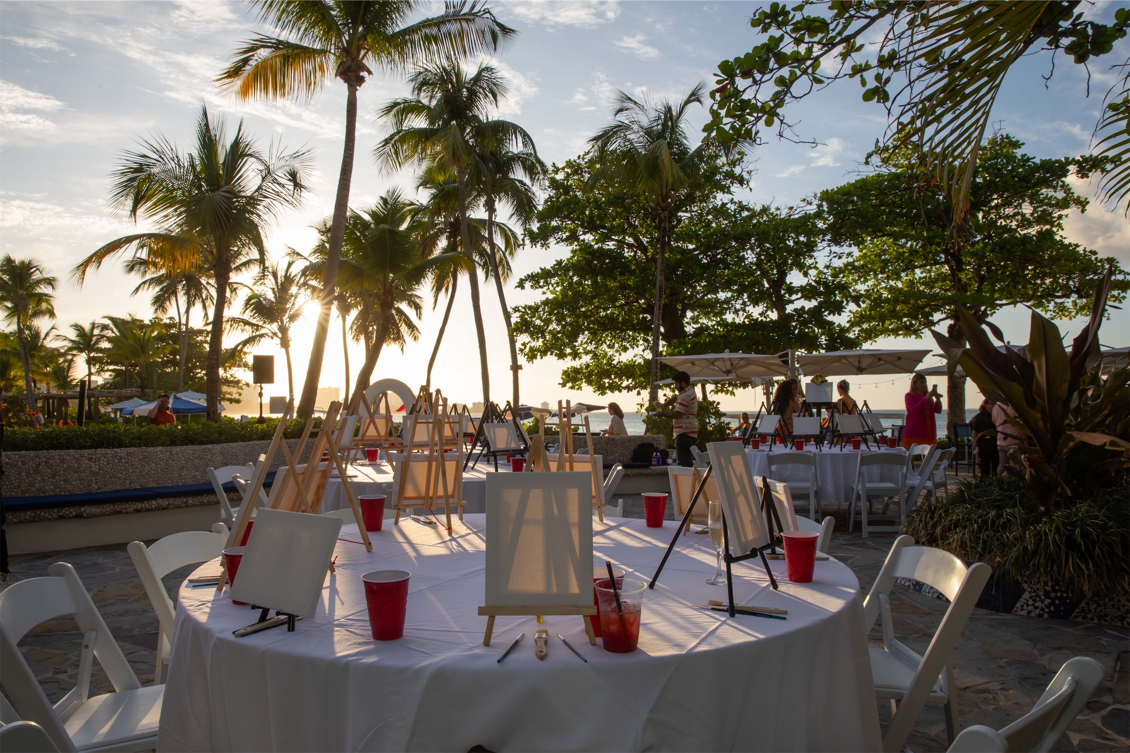 outdoor venue with round tables set up for a paint night