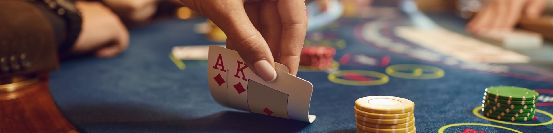 person playing blackjack looking at their cards
