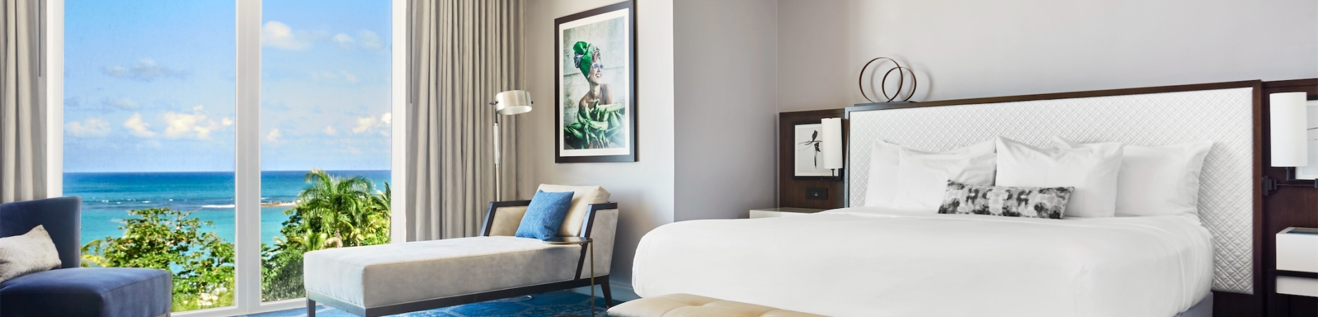 queen sized bed in a room with chair and lounge