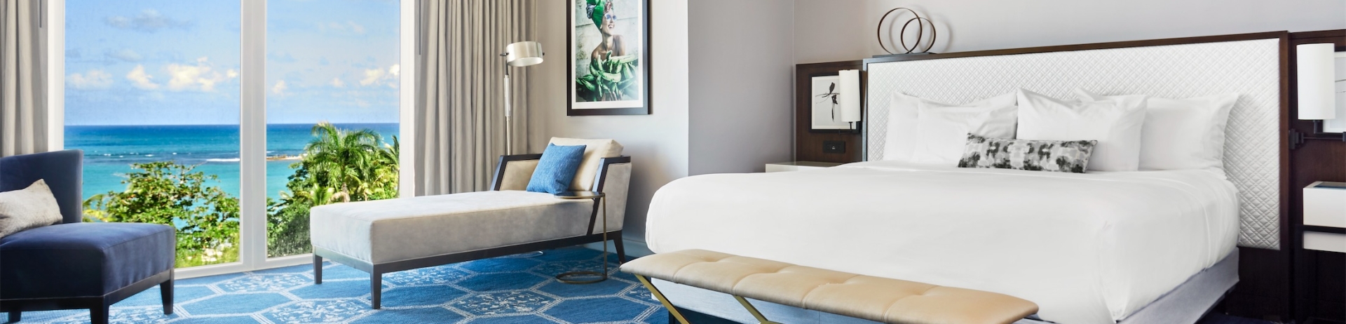 queen sized bed in a room with chair and lounge