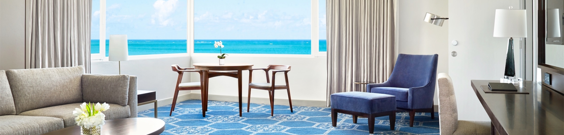 suite area with desk, seating and table