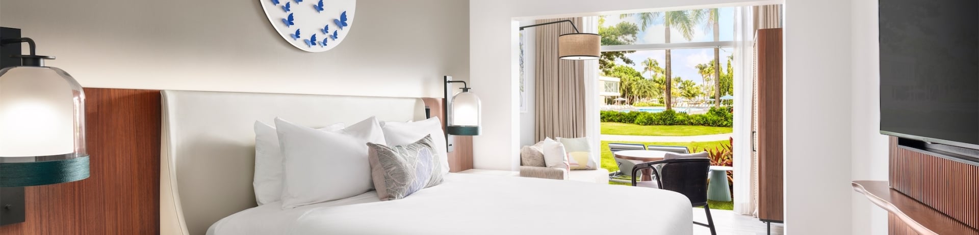 room with queen sized bed and television