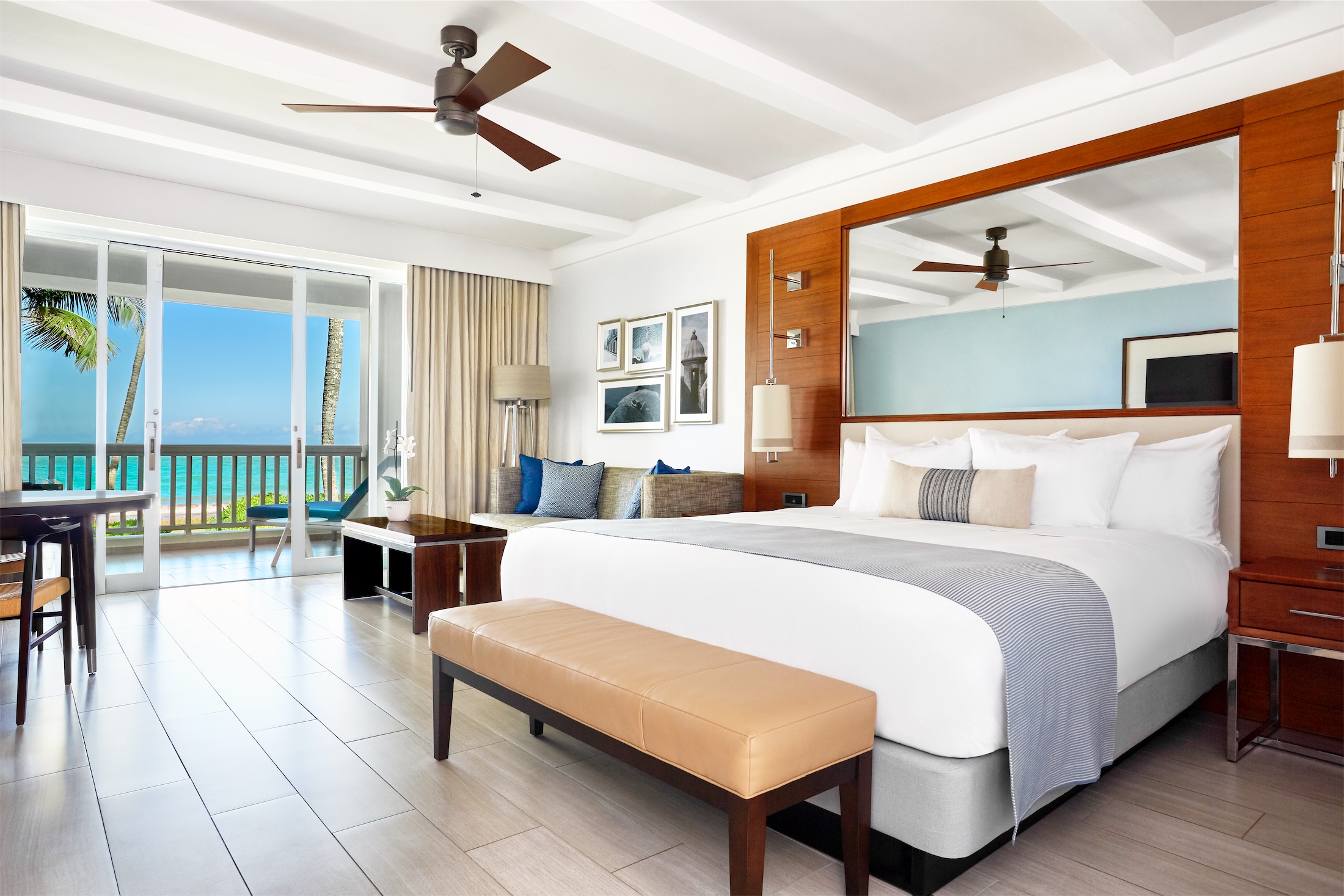 king sized bed in a room with a large mirror