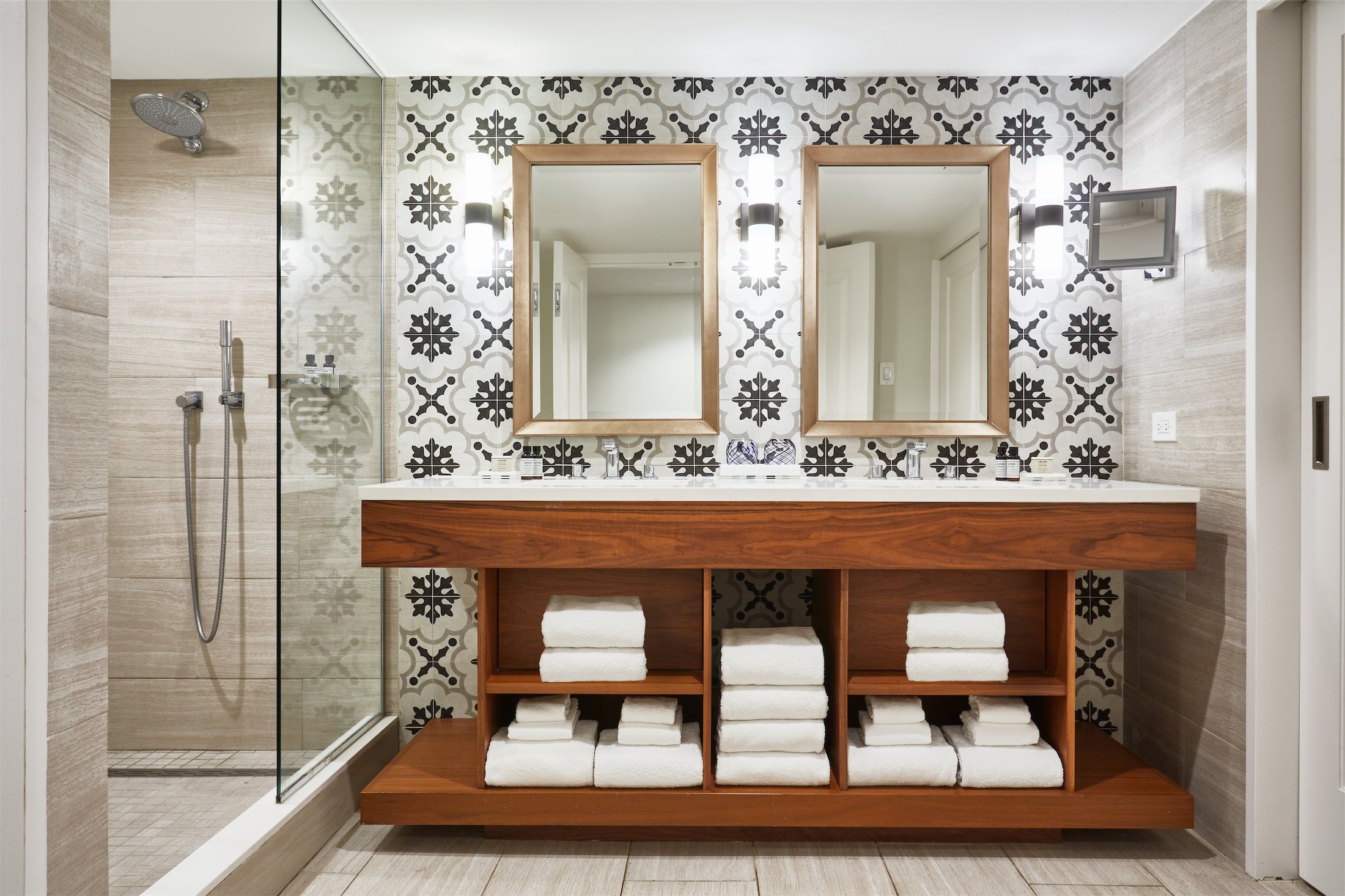 bathroom with 2 mirrors and folded towels