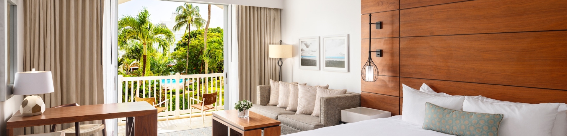 hotel room with a king sized bed and balcony