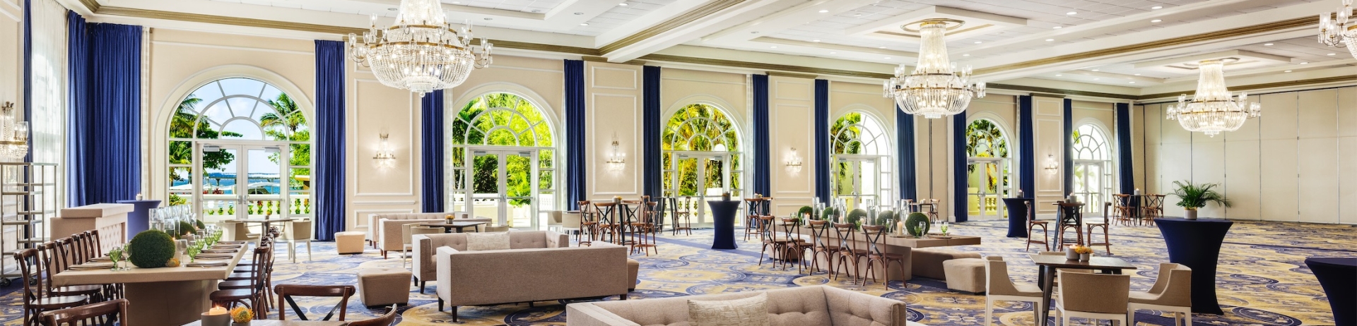 open area set up for a social event with tables and seating