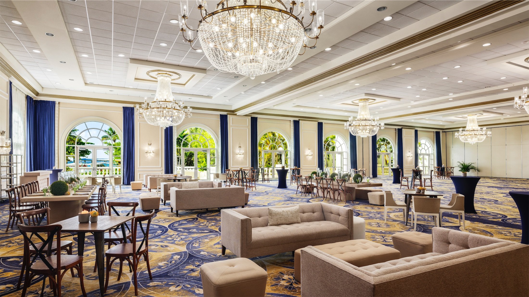 open area set up for a social event with tables and seating