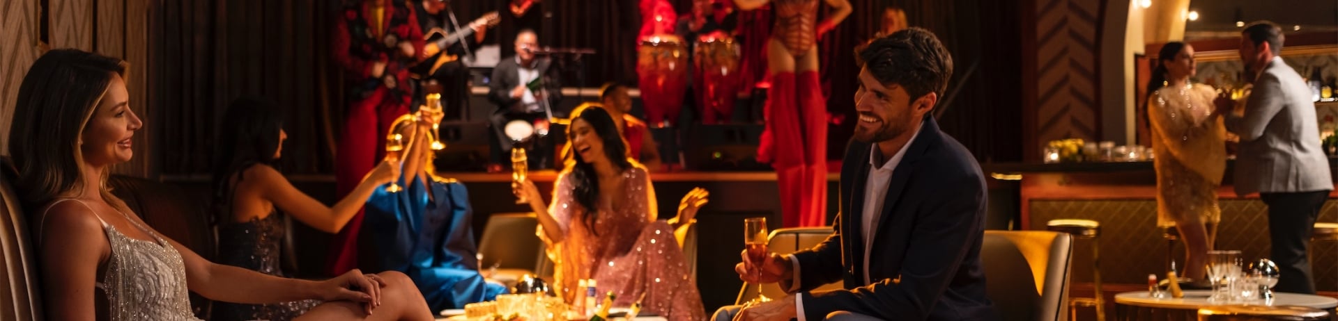 couple sharing drinks at a bar with live music