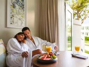 couple in bathrobes sitting on a sofa