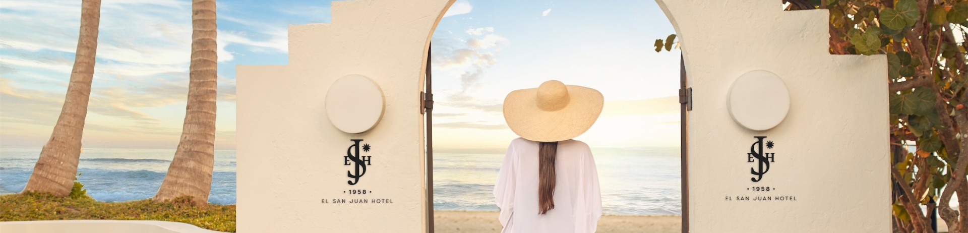 woman entering an archway by the beach