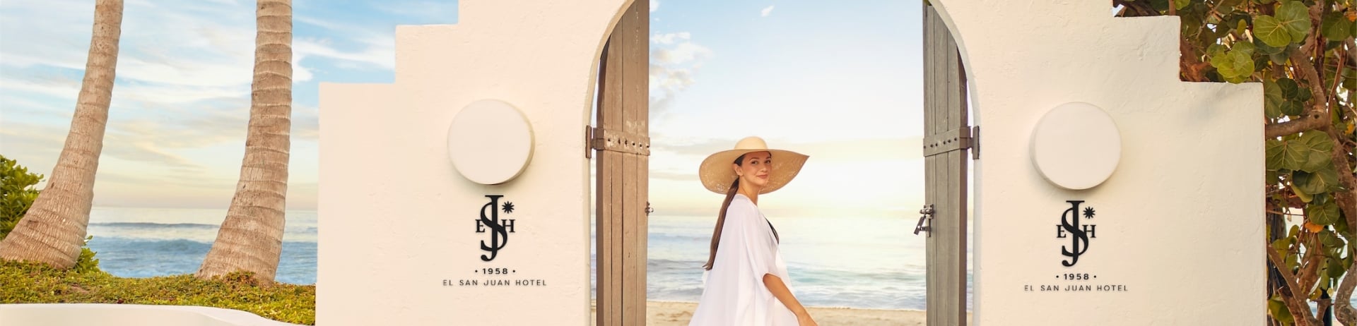 woman standing in an archway by the beach