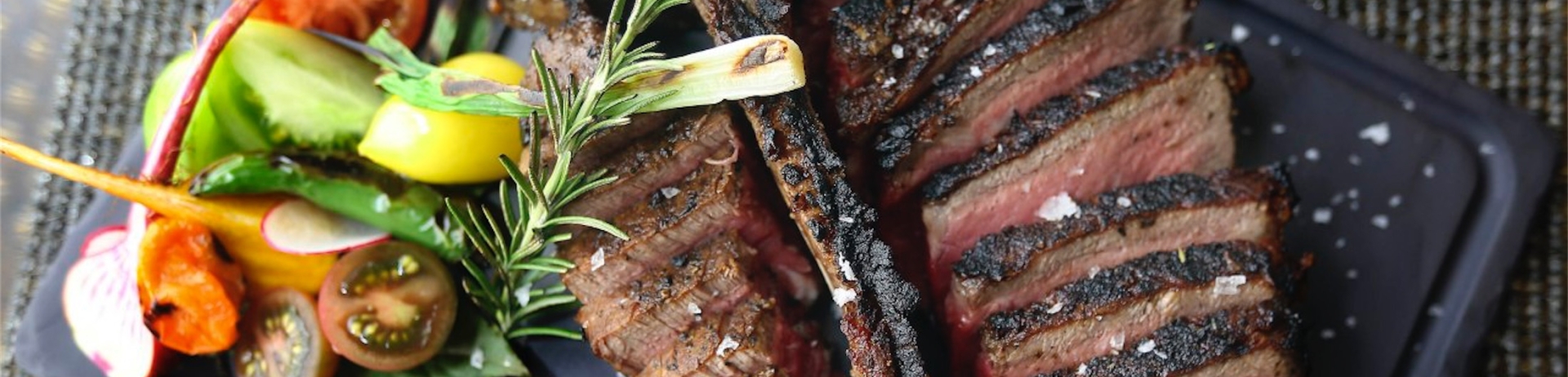 meat on a platter with a side of vegetables