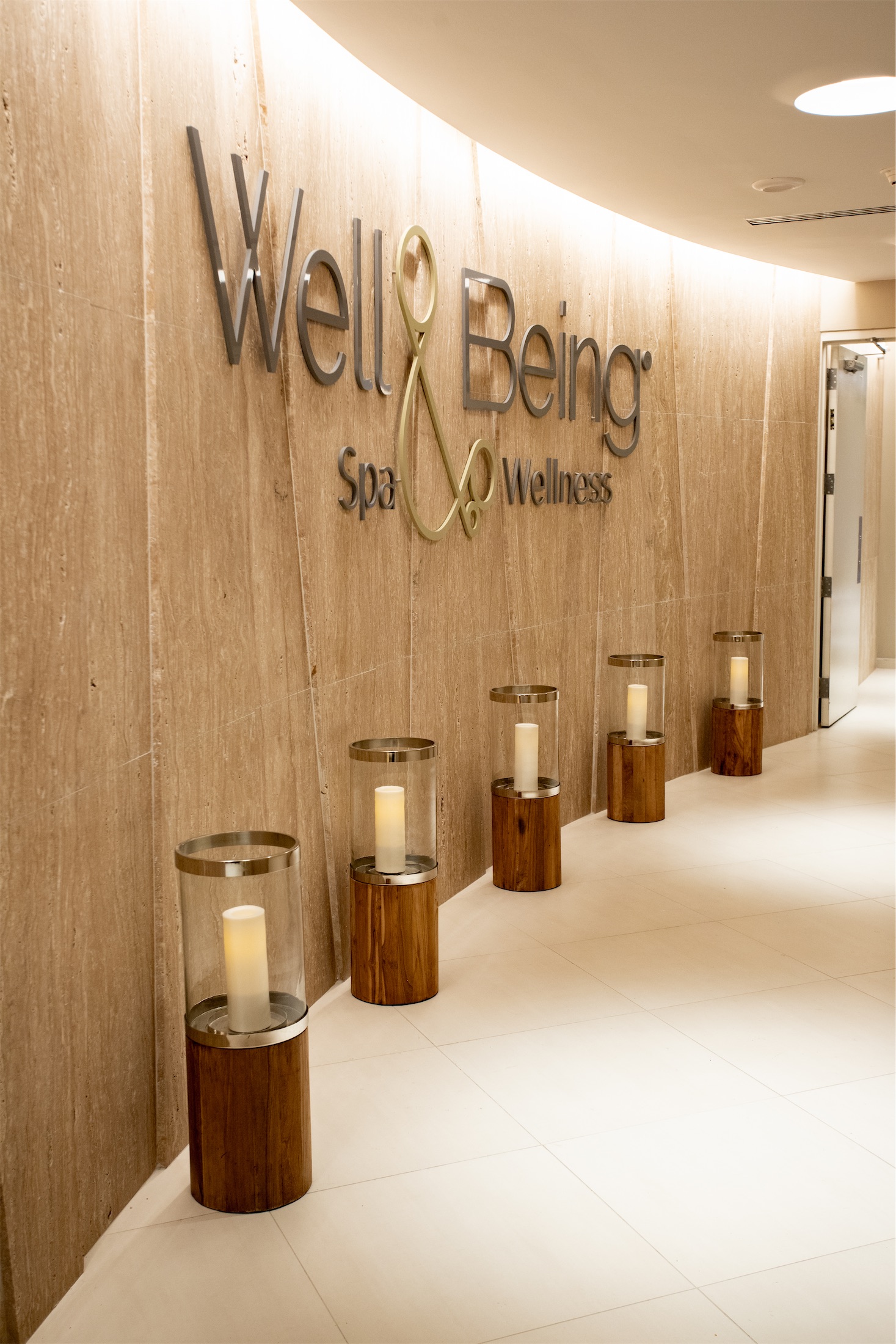 several candles in glass cases outside a spa