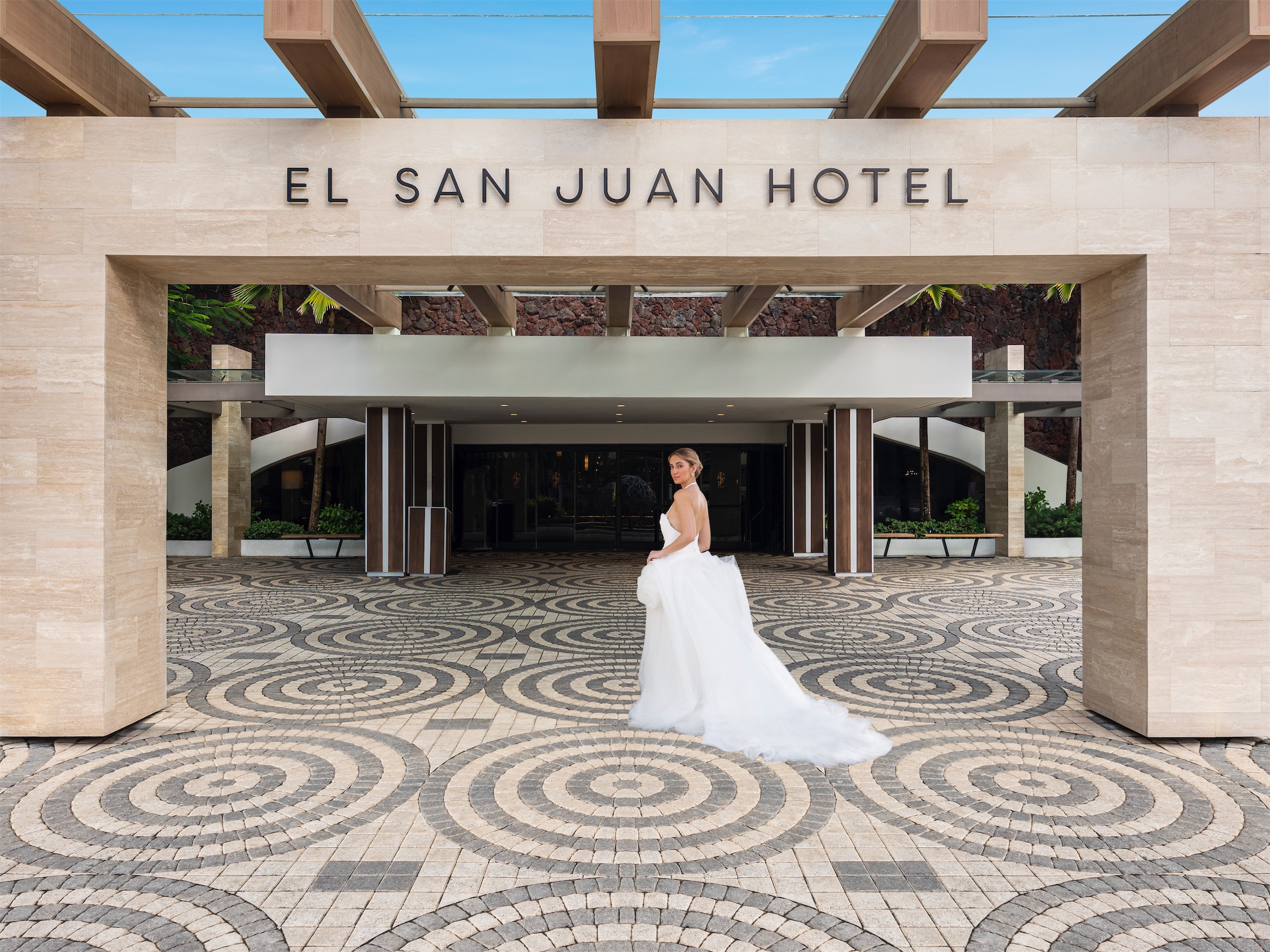 woman in a wedding dress entering el san juan hotel