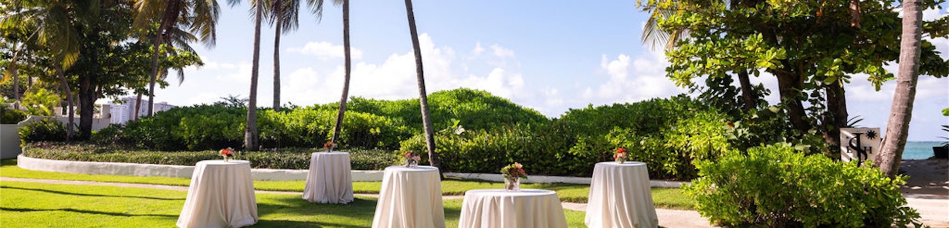 covered tables in a grassy area