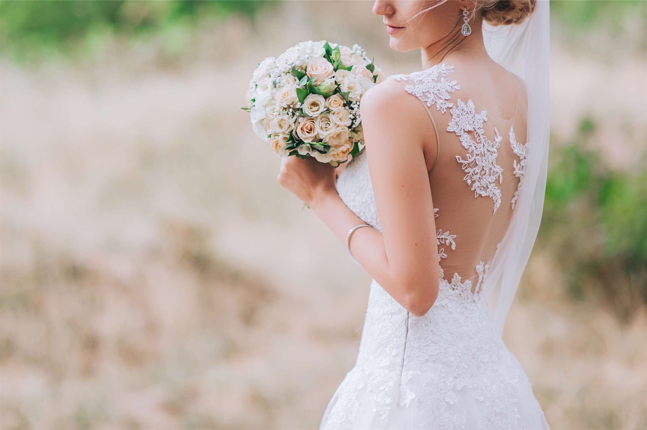 woman wearing a wedding dress and holding a bouquet