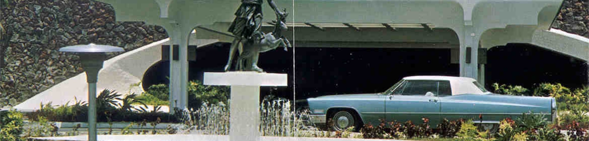 historic photo of a car next to a statue