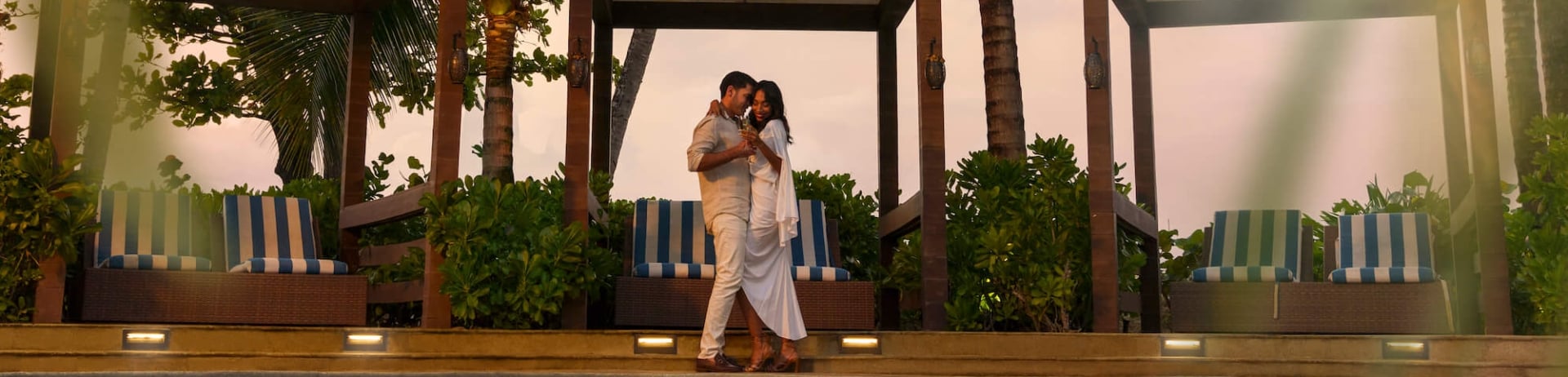 couple standing by the pool