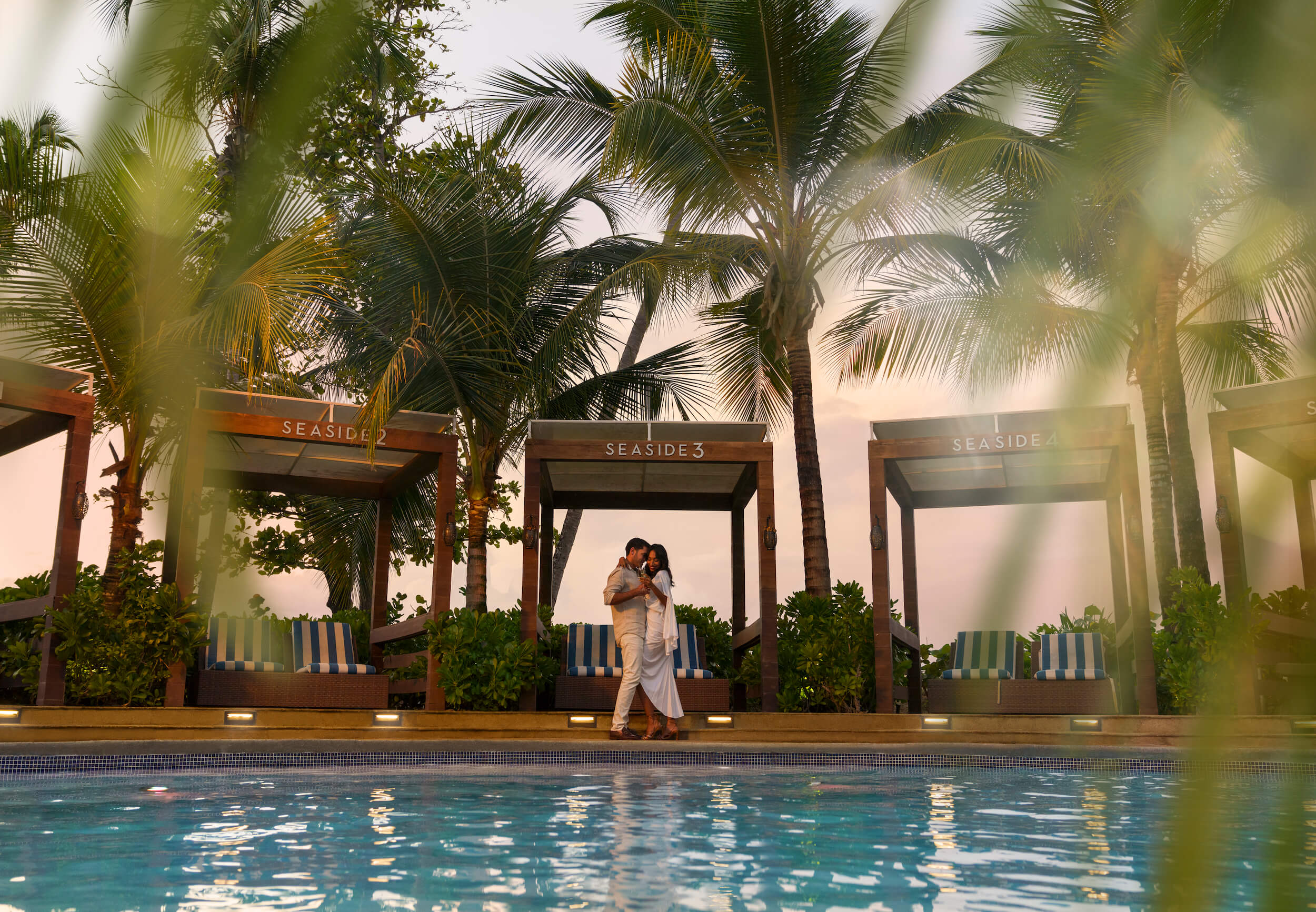 couple standing by the pool